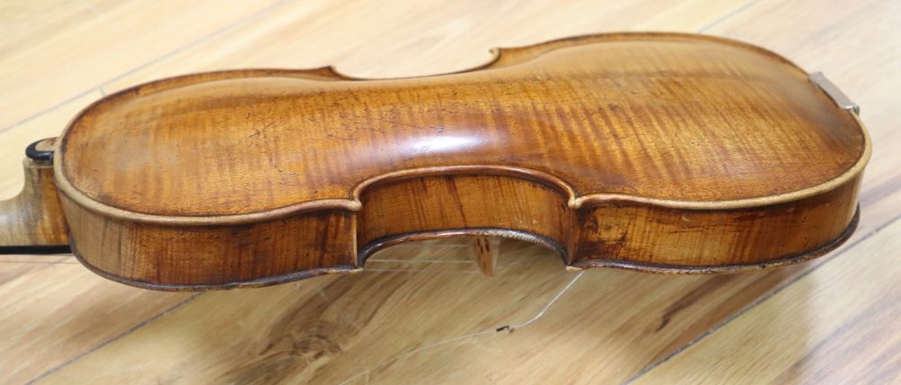 A cased violin with two bows. Violin bears the label Carl Willhelm Claesel, circa late 18th century/early 19th century, 35.5cm back in
